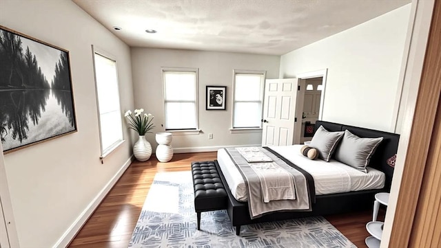bedroom featuring baseboards and wood finished floors