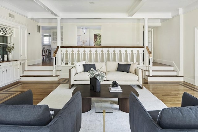 living room with hardwood / wood-style floors, crown molding, and beam ceiling