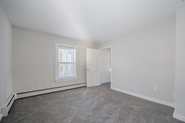 empty room with baseboard heating and carpet flooring