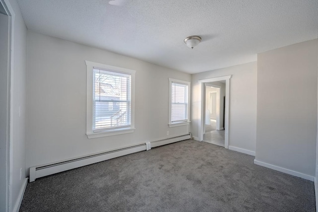 unfurnished room featuring a baseboard radiator, a textured ceiling, and carpet