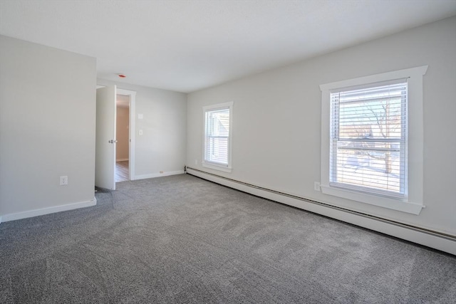 spare room with a baseboard radiator and carpet