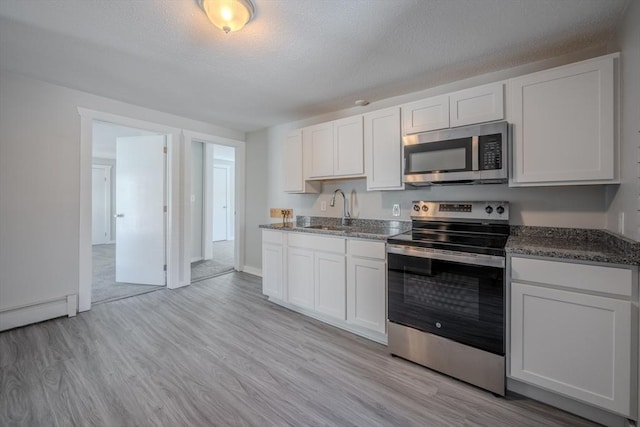 kitchen featuring white cabinetry, appliances with stainless steel finishes, and sink