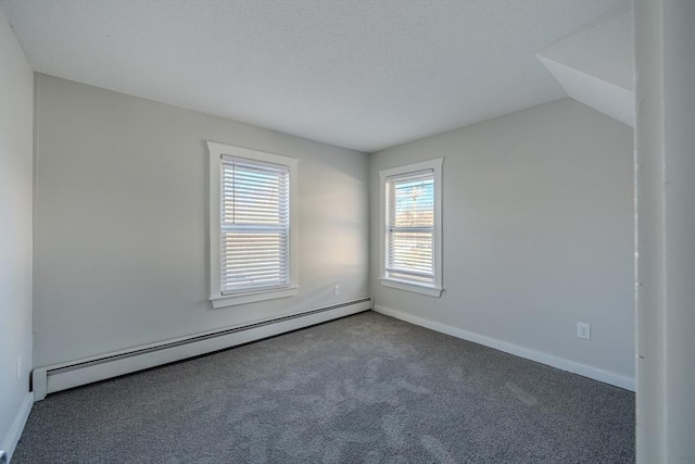 carpeted spare room with baseboard heating and lofted ceiling