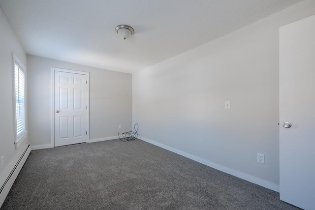 carpeted empty room featuring a baseboard radiator