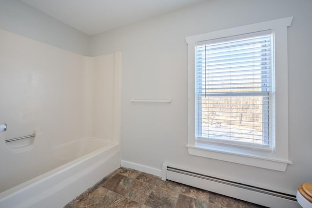 bathroom with a baseboard heating unit and bathing tub / shower combination