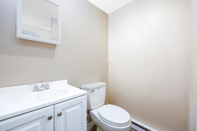 bathroom featuring a baseboard radiator, toilet, and vanity