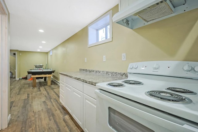 kitchen featuring under cabinet range hood, recessed lighting, electric stove, wood finished floors, and white cabinets