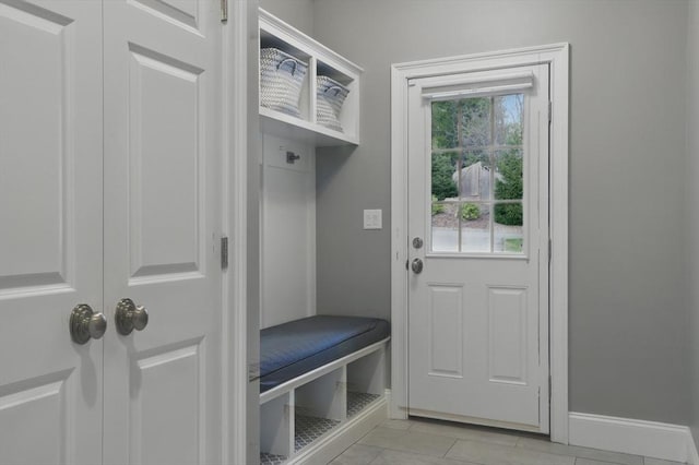 mudroom featuring baseboards and light tile patterned floors