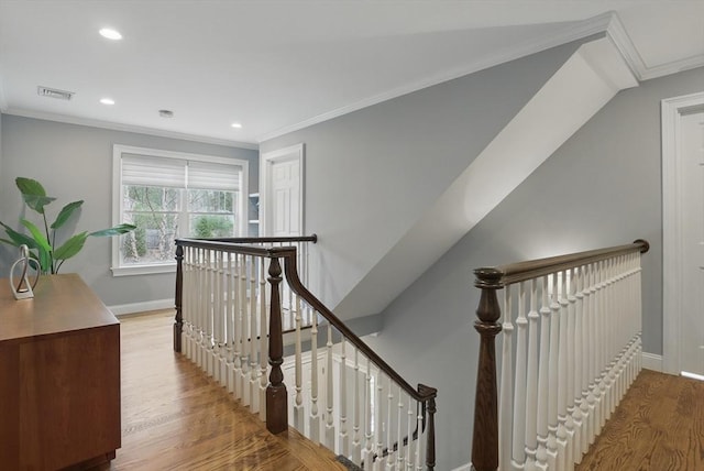 stairway featuring crown molding, visible vents, wood finished floors, baseboards, and recessed lighting