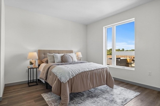 bedroom with dark wood-type flooring