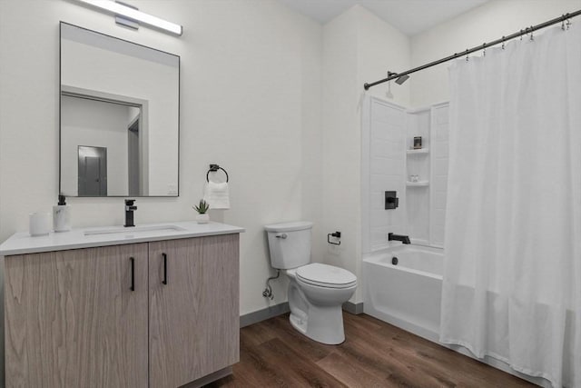 full bathroom with vanity, hardwood / wood-style floors, toilet, and shower / bath combo