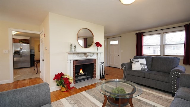 living room featuring a fireplace and light hardwood / wood-style flooring