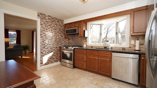 kitchen with tasteful backsplash, sink, appliances with stainless steel finishes, and dark stone counters