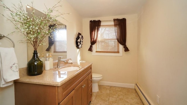 bathroom with vanity, toilet, and baseboard heating