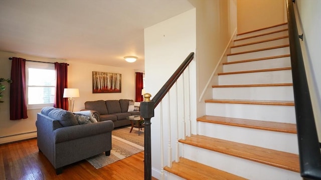 staircase featuring hardwood / wood-style floors and baseboard heating