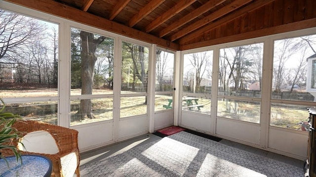 sunroom / solarium with a healthy amount of sunlight, wooden ceiling, and vaulted ceiling