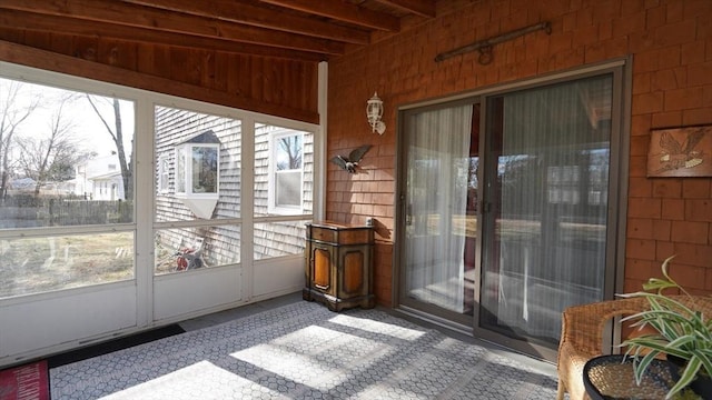 sunroom with beamed ceiling