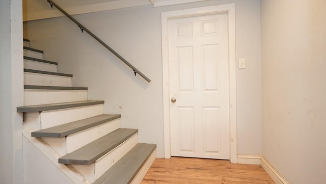 stairs with hardwood / wood-style floors