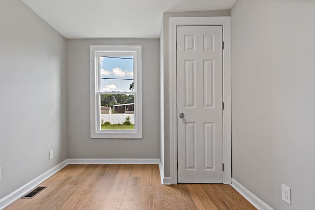 unfurnished room with light wood-type flooring