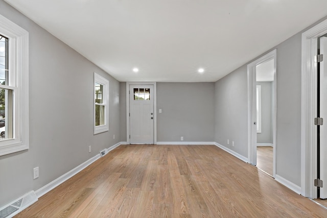 entrance foyer featuring light hardwood / wood-style flooring and a healthy amount of sunlight