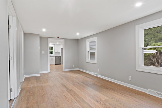 interior space with plenty of natural light and light hardwood / wood-style floors