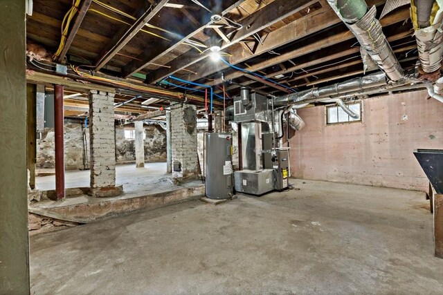 basement featuring heating unit and water heater