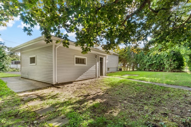 back of house with a lawn