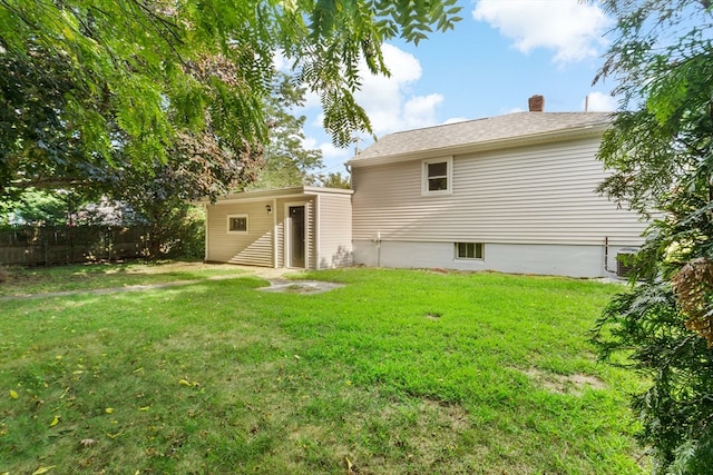 back of house featuring a yard