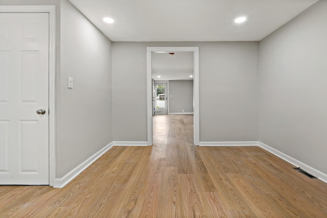 corridor with light hardwood / wood-style floors