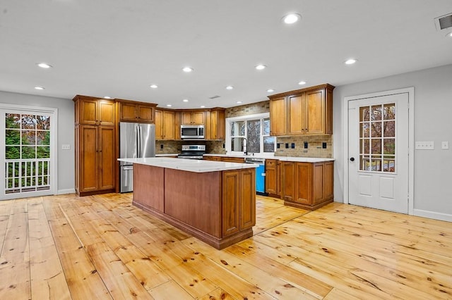 853 Oxford St S, Auburn, MA 01501 - kitchen featuring appliances with stainless steel finishes, light wood-type flooring, light countertops, healthy amount of natural light, and recessed lighting