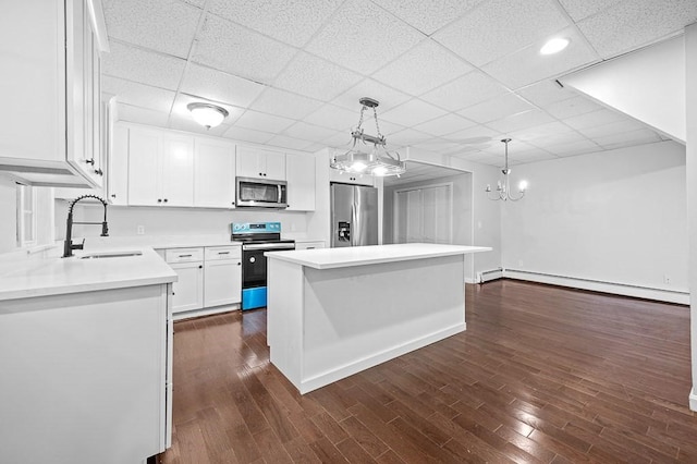 853 Oxford St S, Auburn, MA 01501 - kitchen featuring stainless steel appliances, a sink, white cabinets, a chandelier, and baseboard heating