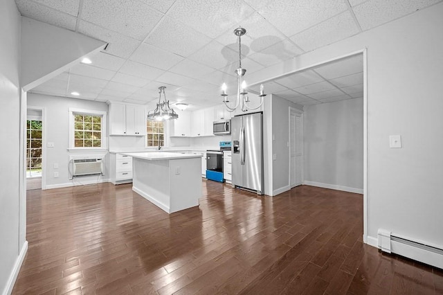 853 Oxford St S, Auburn, MA 01501 - kitchen featuring stainless steel appliances, a paneled ceiling, a baseboard radiator, a chandelier, and dark wood finished floors