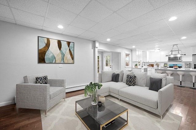 853 Oxford St S, Auburn, MA 01501 - living area featuring light wood-style flooring, baseboard heating, recessed lighting, baseboards, and a paneled ceiling