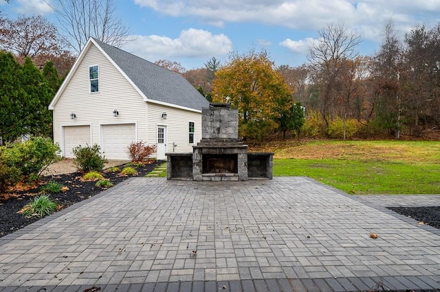 853 Oxford St S, Auburn, MA 01501 - view of patio / terrace featuring an outdoor stone fireplace and a garage