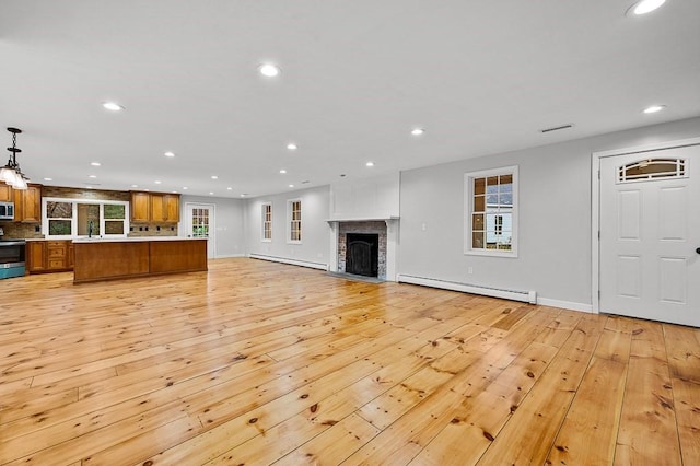 853 Oxford St S, Auburn, MA 01501 - unfurnished living room featuring a baseboard heating unit, light wood-style flooring, recessed lighting, a fireplace, and baseboards