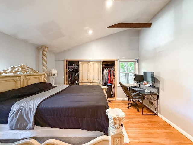 bedroom with light hardwood / wood-style flooring, a closet, and lofted ceiling with beams