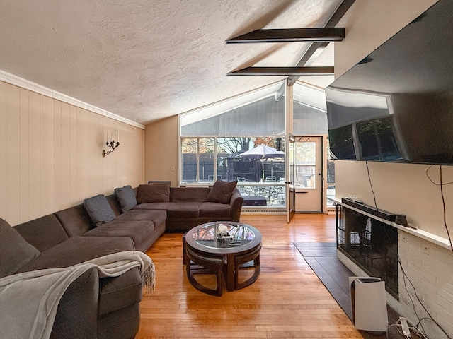 living room featuring vaulted ceiling with beams, crown molding, a textured ceiling, and wood-type flooring