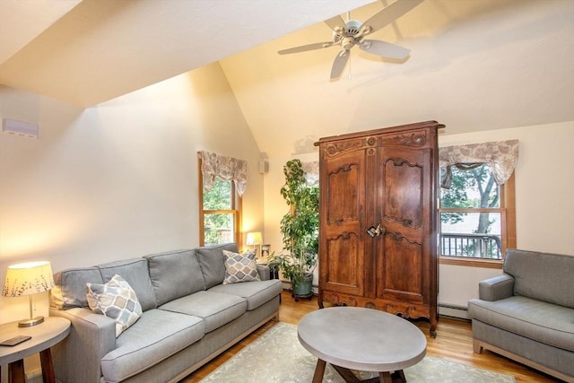 56 Carver St, Pembroke, MA 02359 - living room with light wood-style floors, ceiling fan, high vaulted ceiling, and a baseboard radiator
