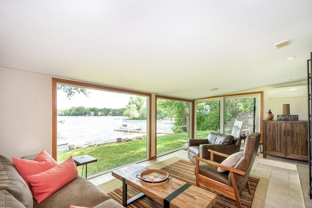 56 Carver St, Pembroke, MA 02359 - living area featuring a water view, a wall unit AC, light tile patterned floors, and a wall of windows