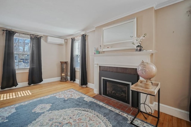 living area featuring wood finished floors, a wealth of natural light, and crown molding