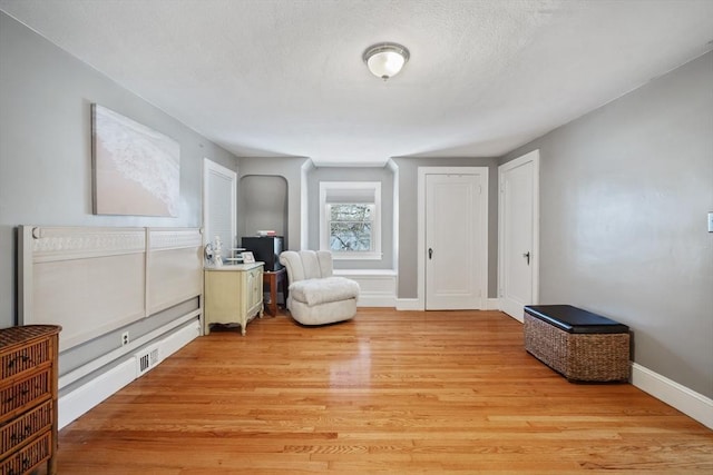 sitting room featuring light wood-type flooring and baseboards