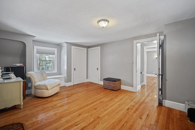 sitting room featuring light wood-style flooring and baseboards