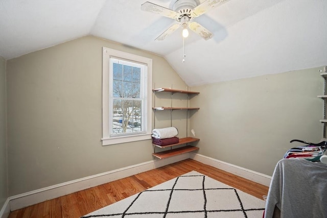 interior space featuring lofted ceiling, a ceiling fan, light wood-style flooring, and baseboards