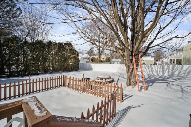 snow covered deck featuring fence