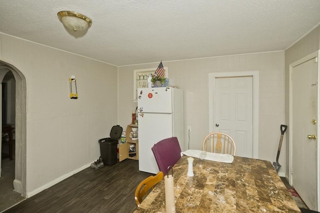74 Everett St, Springfield, MA 01104 - dining space with arched walkways, a textured ceiling, and dark wood finished floors