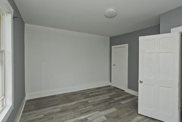 74 Everett St, Springfield, MA 01104 - unfurnished bedroom with baseboards and dark wood finished floors