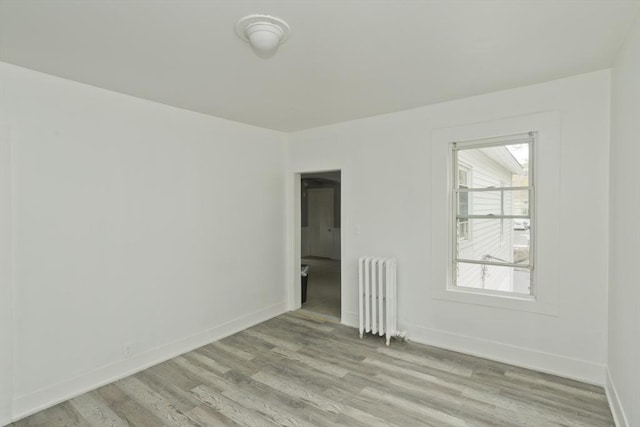 74 Everett St, Springfield, MA 01104 - spare room with baseboards, light wood finished floors, and radiator heating unit