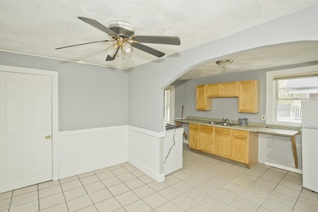 74 Everett St, Springfield, MA 01104 - kitchen featuring arched walkways, a sink, light countertops, freestanding refrigerator, and light brown cabinets