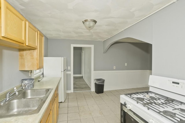 74 Everett St, Springfield, MA 01104 - kitchen with light tile patterned flooring, a sink, light brown cabinets, white appliances, and light countertops