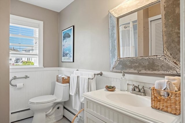 12 14th St, Newbury, MA 01951 - bathroom with baseboard heating, a wainscoted wall, toilet, and vanity